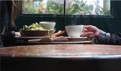 Enjoying the energy healing community Table set with tea and food at a café, representing a Discover Healing event